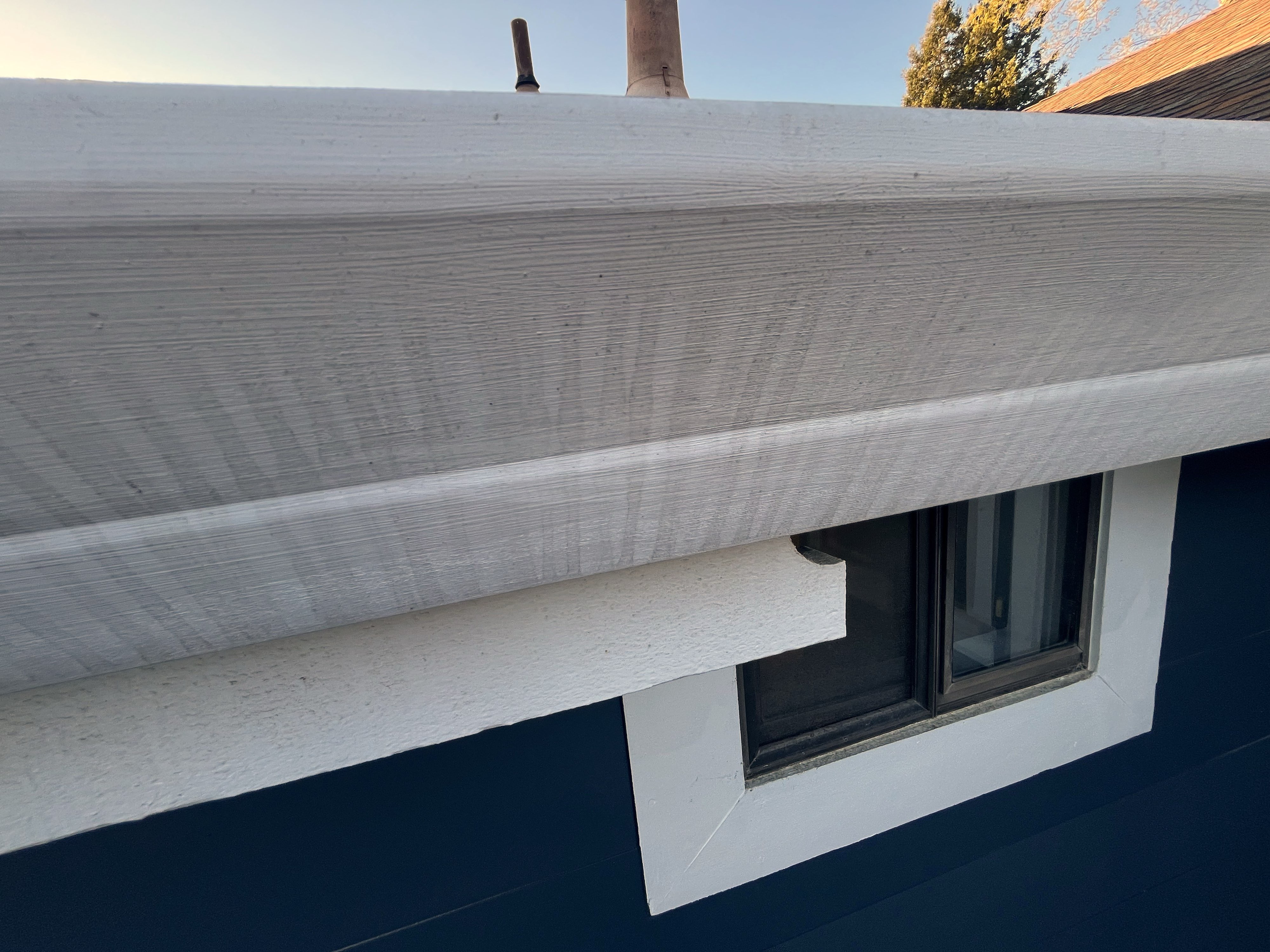 Vertical gray streaks running down the front face of a white painted steel gutter on Chadwick Way in Cotati, California — overflow marks documenting repeated storm overflow over multiple seasons
